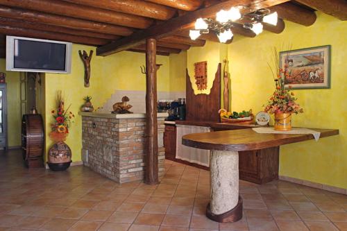 a kitchen with a table and a fireplace in a room at ALL'ALBARO AGRITURISMO in Salizzole