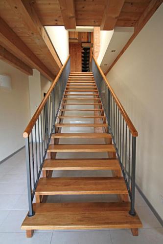 a staircase with wooden steps in a building at ALL'ALBARO AGRITURISMO in Salizzole