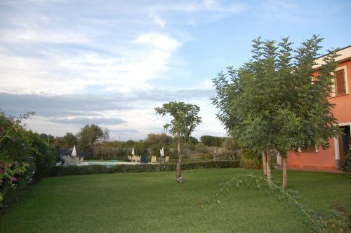 a yard with two trees and a house at Case Vacanze Residence Trinacria in Acireale