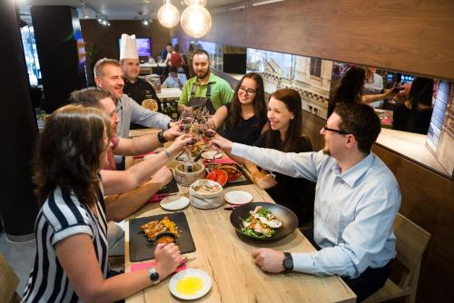 a group of people sitting around a table eating food at Mercure Budapest City Center in Budapest