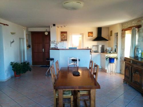 a kitchen with a wooden table and chairs in it at Gite de Lafargue in Cazes-Mondenard