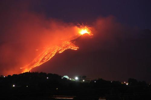a fire on a hill at night at Etna Hotel in Giarre