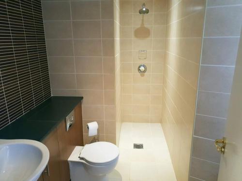 a bathroom with a shower and a toilet and a sink at Mansfield House Hotel in Hawick