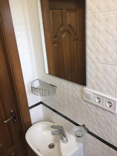 a bathroom with a sink and a mirror at Polyana Apart in Polyana