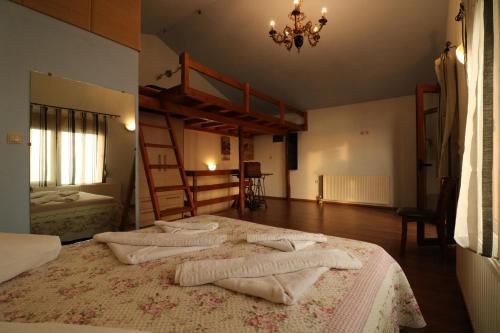 a bedroom with two bunk beds and a chandelier at Fakistra's Blue House in Tsagarada