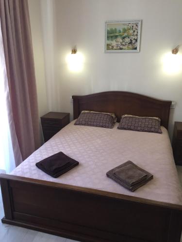 a bedroom with a large bed with two pillows on it at Polyana Apart in Polyana