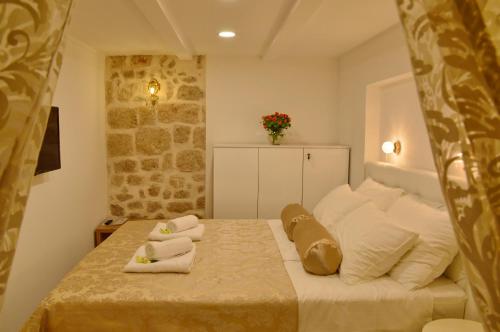 a bedroom with a bed with towels on it at Villa Madonna della Strada A3 in Dubrovnik