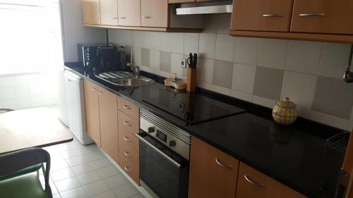 a kitchen with a black counter top and a sink at Lisbon Location in Lisbon