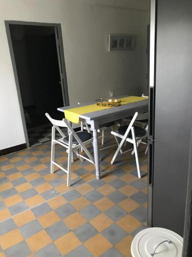 a table and chairs in a room with a floor at Clos Augusta in Riez