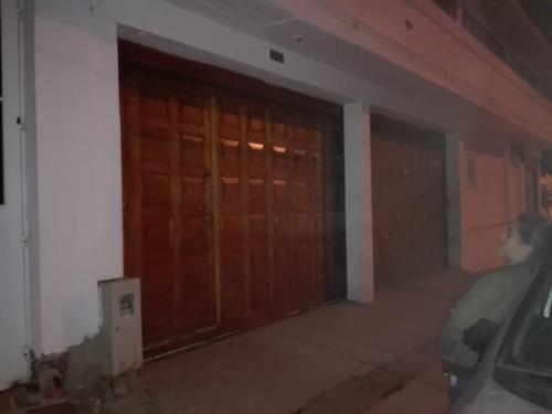 a room with two wooden doors in a building at Family Haclams in Zipaquirá