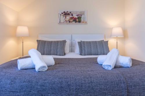 a large bed with white pillows on top of it at Ailsa Retreat in Troon