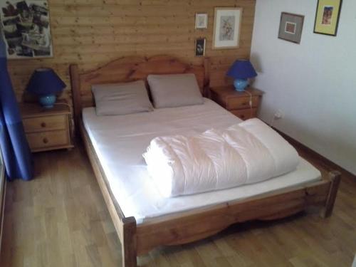 1 dormitorio con 1 cama blanca grande y 2 lámparas en Cordon Balcon Du Mont Blanc, en Cordon