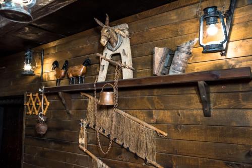 a wall with a shelf with various items on it at Banskovilla Zlateva House in Bansko