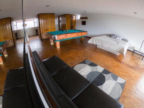 a living room with a pool table and a bed at Suites Las Plazas in Cuernavaca