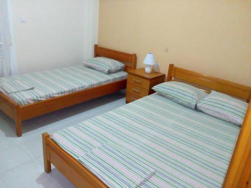 a bedroom with two beds and a night stand at Anastasia Studios in Platamonas