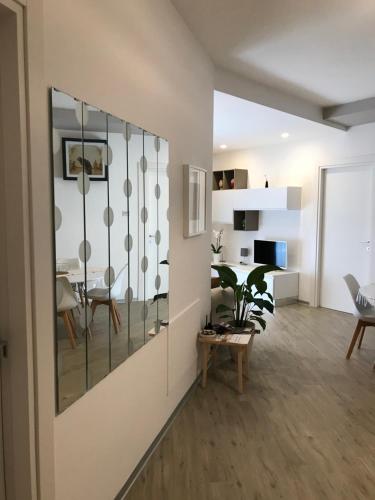 a living room with a table and a dining room at A Matera "Sotto i pini" in Matera