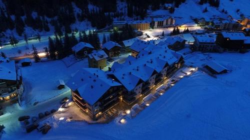 an aerial view of a resort in the snow at night at Hotel Residence 3 Signori in Santa Caterina Valfurva