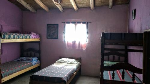 a room with two bunk beds and a window at Casa Colores in Tilcara