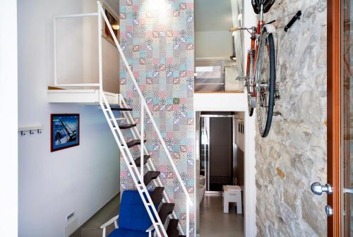 a staircase in a room with a bike hanging on a wall at siciliacasevacanze - Marina Domus Depandance in Marina di Ragusa