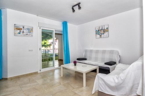 a living room with a couch and a table at Apartamentos Turísticos Zahazar in Zahara de los Atunes
