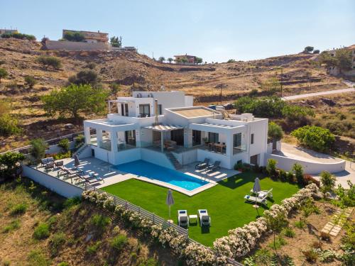 an aerial view of a villa with a swimming pool at Eolia Iconic Villa, walking distance to the beach, By ThinkVilla in Panormos Rethymno