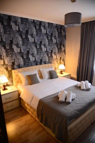 a bedroom with a large bed with two towels on it at Metekhi Vista in Tbilisi City