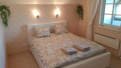 a bedroom with a bed with two pillows on it at Sinilille 7 Holiday Home in Kuressaare