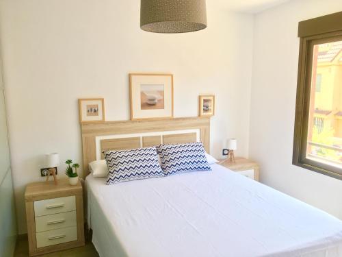 a bedroom with a white bed with two pillows on it at Levante Apartment by Albir Proper Properties in Albir