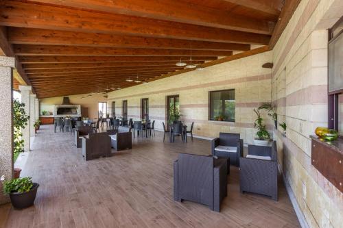 a dining area with tables and chairs in a building at Rodia Inn in Oristano