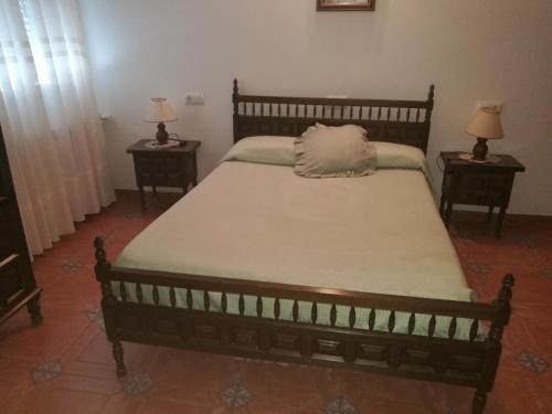 a bed with a pillow on top of it in a room at Casa y Apartamentos Nati in Carrascosa