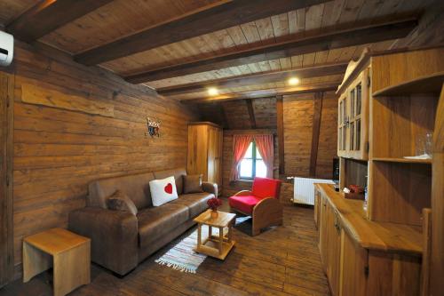 a living room with a couch and a chair at Ethno Houses Plitvice Lakes Hotel in Plitvica selo
