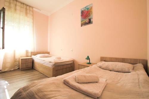 a bedroom with two beds and a window at Skier's House in Mestia