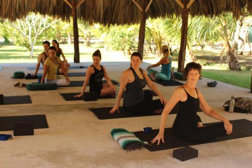 a group of people doing yoga on the beach at The Crimson Orchid Inn at Orchid Bay in Corozal