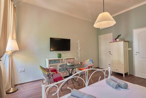 a living room with a table and chairs and a tv at Old City Romanitic Studios 1 with FREE private parking in Pula