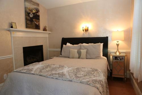 a bedroom with a bed and a fireplace at Martha's Vineyard B & B in South Haven