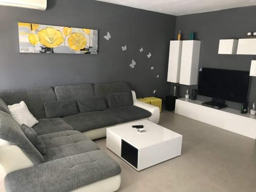 a living room with a couch and a tv at Apartment Vukovarska in Zadar