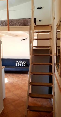 a ladder leading up to a bunk bed at Mini Loft Porto Torres in Porto Torres