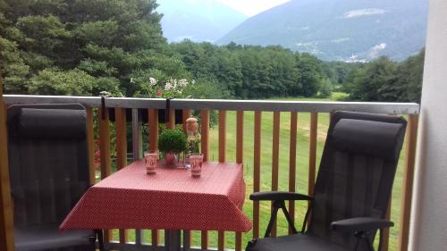 a table on a balcony with a table and two chairs at Bauernhof Residence Hausergut with Ortler views, central and quiet position in Sluderno