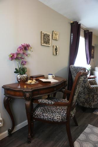 a room with a table and a chair with flowers on it at Martha's Vineyard B & B in South Haven