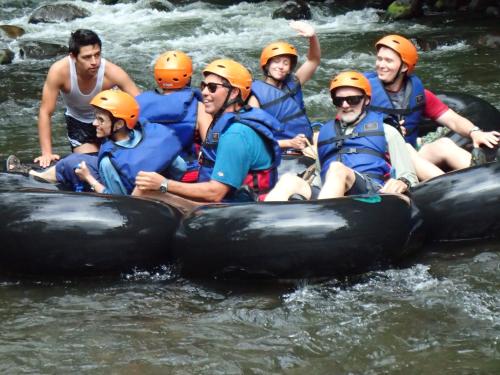 a group of people in rafts in the water at Casa Divina Eco Lodge in Mindo