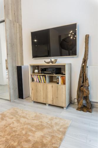 a living room with a flat screen tv on a wall at Premium Apartment Centrum in Poprad