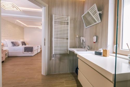 a bathroom with a sink and a bed in a room at Splendido MB Apartments in Tivat