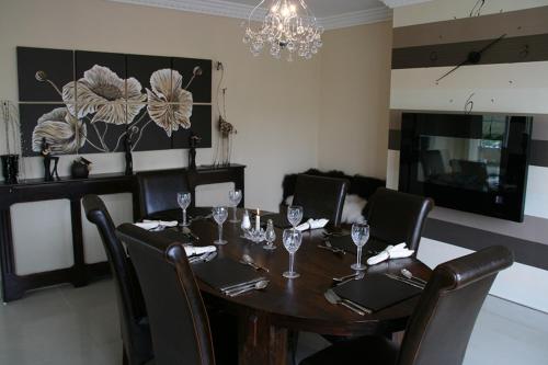 a dining room table with chairs and wine glasses at Cherville Bed & Breakfast in Cavan