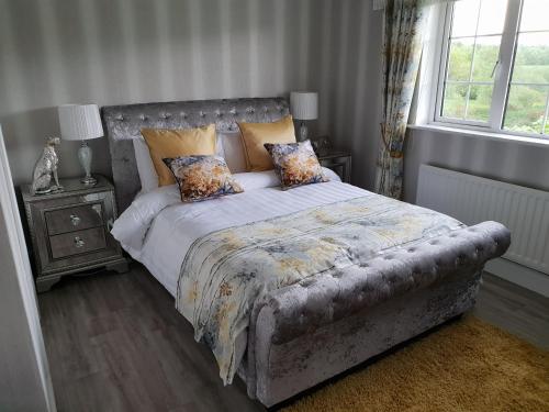 a bedroom with a bed with a tufted headboard at Cherville Bed & Breakfast in Cavan