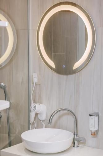 a bathroom with a white sink and a mirror at Splendido MB Apartments in Tivat