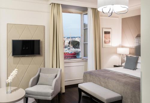 a hotel room with a bed and a window at Bastion Heritage Hotel - Relais & Ch&acirc;teaux in Zadar