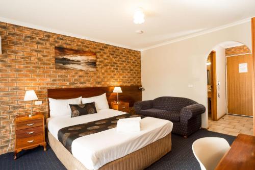 a hotel room with a bed and a dresser at Hume Country Motor Inn in Albury