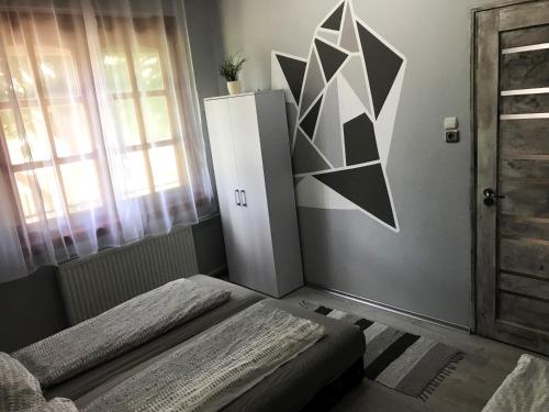 a room with a white refrigerator and a window at Varga Vendégház in Tiszakécske