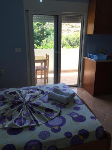 a bedroom with a table with an umbrella on it at Mana Apartments in Ksamil
