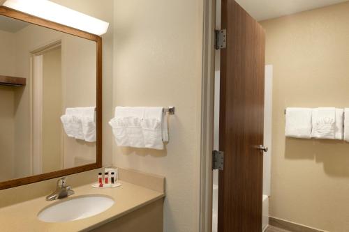 a bathroom with a sink and a mirror at Baymont by Wyndham Salina in Salina